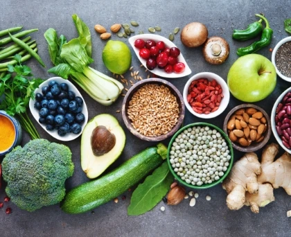 various vegetables, nuts and fruits laid out on a table